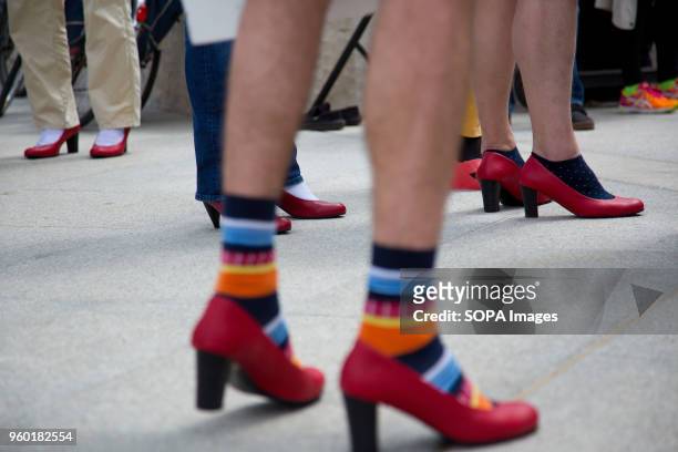 Men wore high-heeled shoes in order to show solidarity with women and the struggles they face during the "Walk a Mile in Her Shoes campaign to draw...