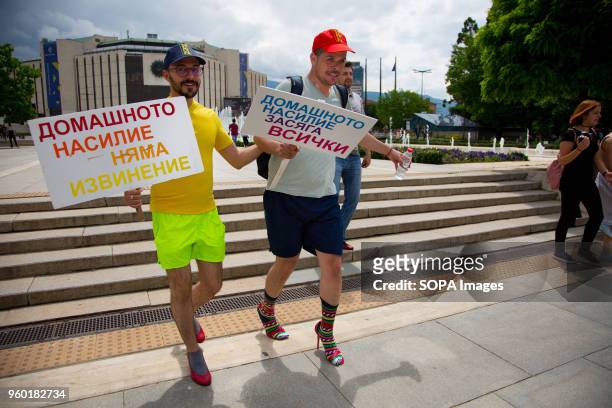 Momchil Baev, left, and Luis Lomeli were among the participants in the "Walk a Mile in Her Shoes" campaign held in the center of Sofia. The event, in...