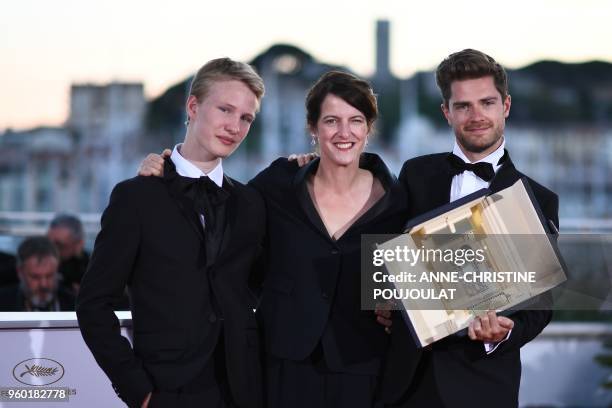 Swiss director and President of the Camera d'Or jury Ursula Meier poses with Belgian director Lukas Dhont and Belgian actor Victor Polster on May 19,...