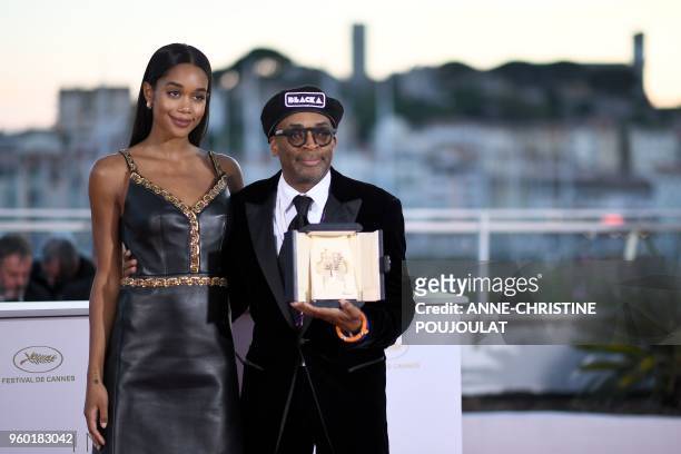 Director Spike Lee poses with his trophy on May 19, 2018 next to US actress Laura Harrier during a photocall after he won the Grand Prix for the film...