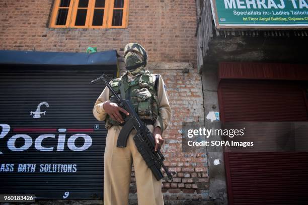 An Indian paramilitary trooper stands guard during restrictions imposed ahead of Indian PM Narendra Modi's visit in Srinagar, Indian administered...