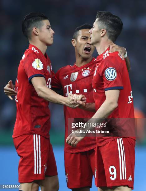 Robert Lewandowski of Bayern Muenchen celebrates with James Rodriguez of Bayern Muenchen and Thiago Alcantara of Bayern Muenchen after he scored a...