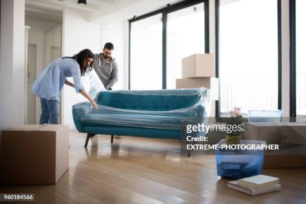 couple and sofa - furniture stock pictures, royalty-free photos & images