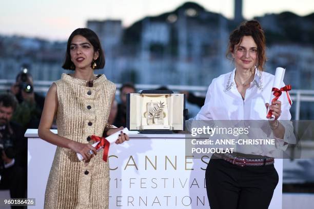 Iranian actress and daughter of Jafar Panahi Solmaz Panahi and Italian director Alice Rohrwacher pose with the trophy on May 19, 2018 during a...