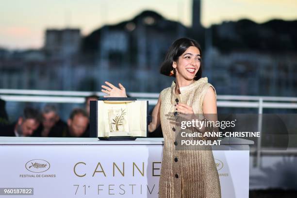 Iranian actress and daughter of Jafar Panahi Solmaz Panahi poses with the trophy on May 19, 2018 during a photocall after her father jointly won the...