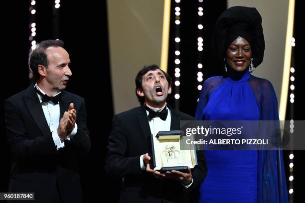 Italian actor Marcello Fonte poses on stage with Italian actor Roberto Benigni and Burundian singer and member of the Feature Film Jury Khadja Nin on...