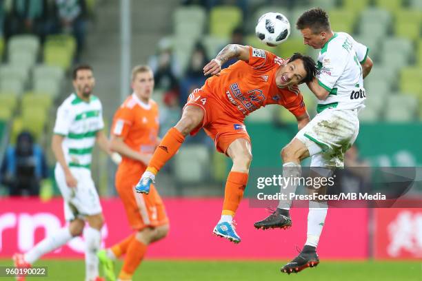 Gabriel Matei of Bruk Bet Termalica Nieciecza competes with Slawomir Peszko of Lechia Gdansk during Lotto Ekstraklasa match between Lechia Gdansk and...