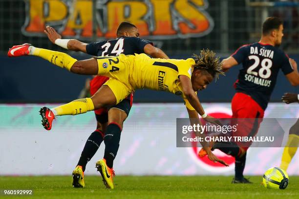 Caen's French defender Alexander Djiku vies for the ball with Paris Saint-Germain's midfielder Christopher Nkunku during the French L1 football match...