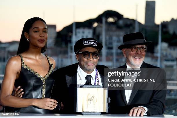 Director Spike Lee poses with his trophy on May 19, 2018 next to US actress Laura Harrier and a guest during a photocall after he won the Grand Prix...