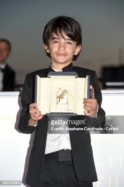 Actor Zain Alrafeea poses with Director Nadine Labaki's Jury Prize award for 'Capharnaum' at the Palme D'Or Winner Photocall during the 71st annual...