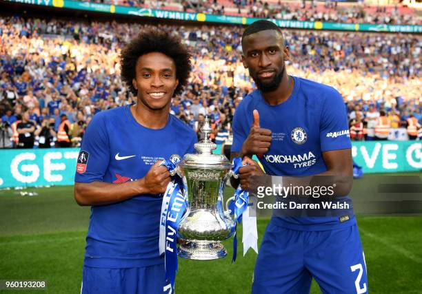 Willian and Antonio Rudiger of Chelsea pose with the Emirates FA Cup trophy following their side's win during The Emirates FA Cup Final between...