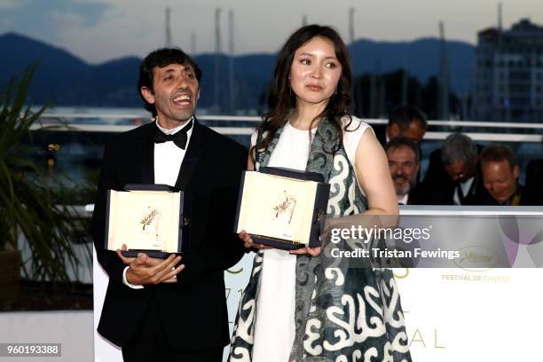 Actress Samal Yeslyamova poses with the Best Actress award for her role in 'Ayka' and actor Marcello Fonte poses with the Best Actor award for his...