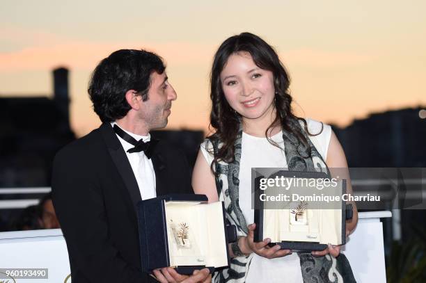 Actress Samal Yeslyamova poses with the Best Actress award for her role in 'Ayka' and actor Marcello Fonte poses with the Best Actor award for his...