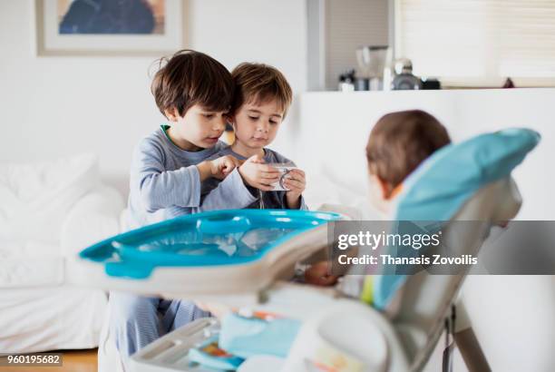 7 year old boy taking photo of his brother - thanasis zovoilis stock pictures, royalty-free photos & images