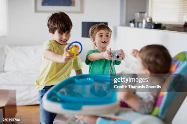 7 year old boy taking photo of his brother - thanasis zovoilis stock pictures, royalty-free photos & images