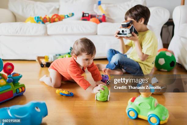 7 year old boy taking photo of his brother - thanasis zovoilis stock pictures, royalty-free photos & images