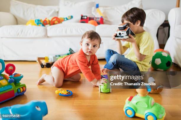 7 year old boy taking photo of his brother - thanasis zovoilis stock pictures, royalty-free photos & images