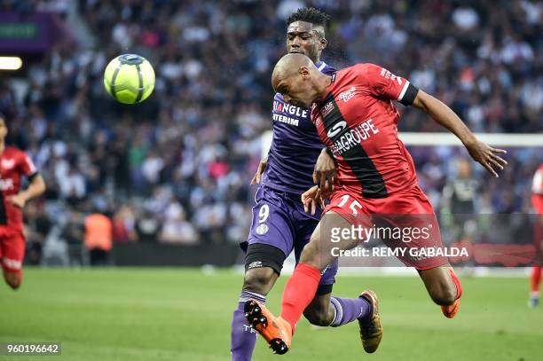 Toulouse's French forward Yaya Sanogo vies for the ball with Guingamp's defender Jeremy Sorbon during the French L1 match between Toulouse and...