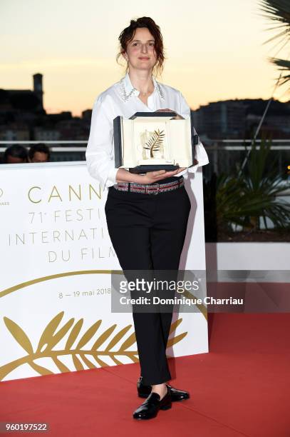 Director Alice Rohrwacher poses with the Best Screenplay award for Happy As Lazzaro at the photocall the Palme D'Or Winner during the 71st annual...