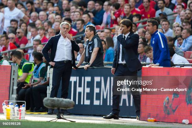 Manchester United manager Jose Mourinho and Chelsea manager Antonio Conte consult with their assistants during the Emirates FA Cup Final match...