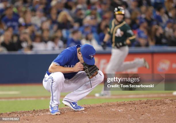 Tyler Clippard of the Toronto Blue Jays reacts after giving up a grand slam home run to Chad Pinder of the Oakland Athletics in the eighth inning...