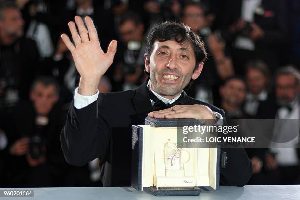 Italian actor Marcello Fonte poses with the trophy on May 19, 2018 during a photocall after he won the Best Actor Prize for his part in "Dogman" at...