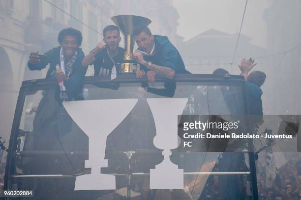 Juan Cuadrado, Miralem Pjanic and Mario Mandzukic of Juventus cheer the fans during a victory Parade by Juventus on May 19, 2018 in Turin, Italy.