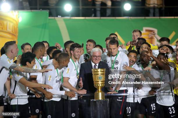 Federal President Frank-Walter Steinmeier hands over the trophy to team Captain David Abraham of Eintracht Frankfurt after winning the DFB Cup final...