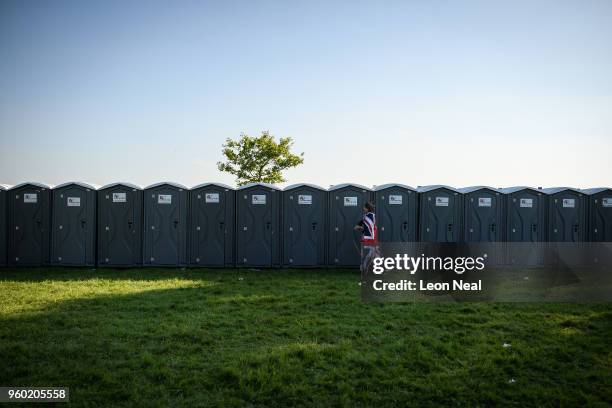 Woman dressed in a Union Flag leaves a portable toilet block, following the marriage of Prince Harry, Duke of Sussex and the Duchess of Sussex at St...