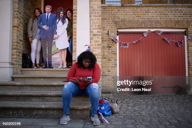 Woman waits for her turn to have her photograph taken with a cardboard cut-out, following the marriage of Prince Harry, Duke of Sussex and the...