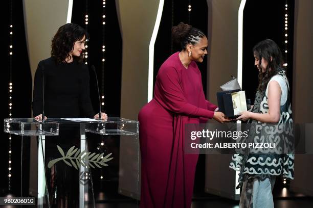 Kazakh actress Samal Yeslyamova receives her trophy from US director and screenwriter and member of the Feature Film Jury Ava DuVernay next to...