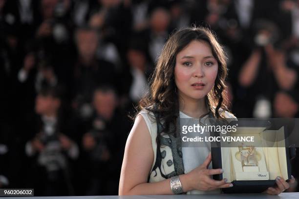 Kazakh actress Samal Yeslyamova poses with her trophy on May 19, 2018 during a photocall after she won the Best Actress Prize for her part in "Ayka "...