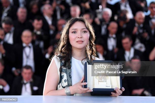 Actress Samal Yeslyamova poses with the Best Actress award for her role in 'Ayka' at the photocall for the Palme D'Or Winner during the 71st annual...