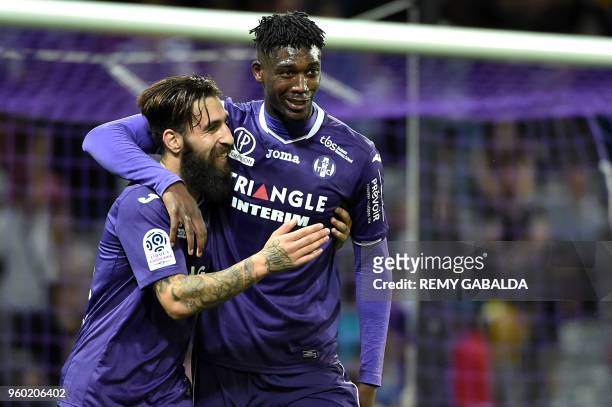 Toulouse's forward Yaya Sanogo celebrates with teammate Jakup Durmaz after scoring his team's second goal during the French L1 football match between...