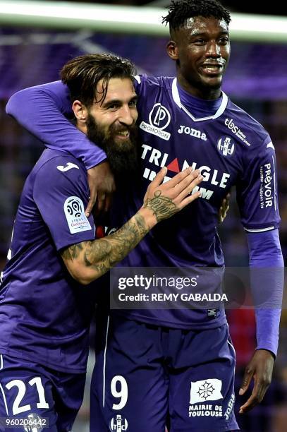 Toulouse's forward Yaya Sanogo celebrates with teammate Jakup Durmaz after scoring his team's second goal during the French L1 match between Toulouse...