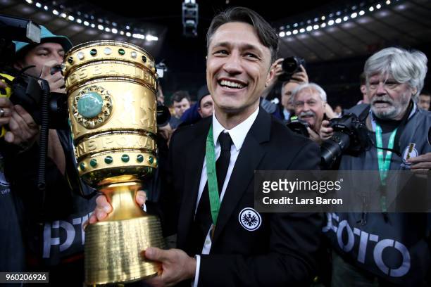 Head coach of Eintracht Frankfurt Niko Kovac caries the DFB Cup trophy after winning the DFB Cup final against Bayern Muenchen at Olympiastadion on...