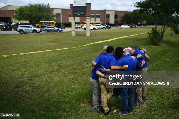 Chaplains from the Billy Graham Rapid Response Team pray on the grounds of Santa Fe High School on May 19 in Santa Fe, Texas. Ten people, mostly...
