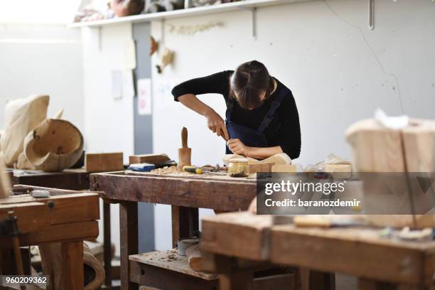 young female sculptor is working in her studio - frieze stock pictures, royalty-free photos & images