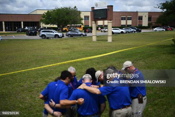 Chaplains from the Billy Graham Rapid Response Team pray on the grounds of Santa Fe High School on May 19 in Santa Fe, Texas. Ten people, mostly...
