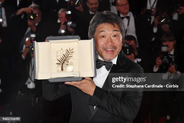 Director Hirokazu Koreeda poses with the Palme d'Or award for 'Shoplifters' at the photocall the Palme D'Or Winner during the 71st annual Cannes Film...