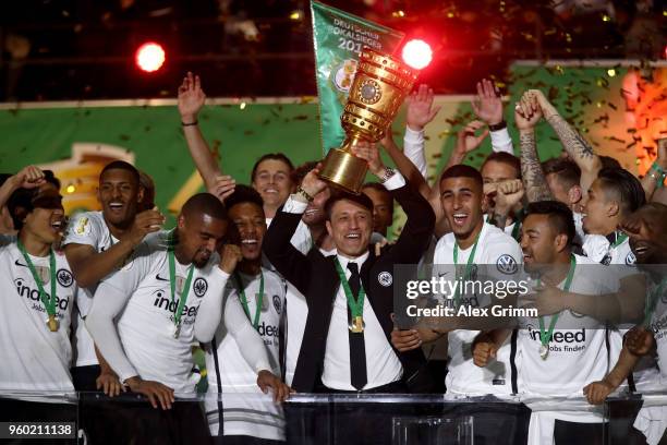 Head coach of Eintracht Frankfurt Niko Kovac lifts the DFB Cup trophy after winning the DFB Cup final against Bayern Muenchen at Olympiastadion on...