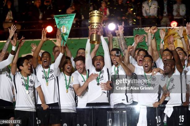 Kevin Prince Boateng of Eintracht Frankfurt lifts the DFB Cup trophy after winning the DFB Cup final against Bayern Muenchen at Olympiastadion on May...