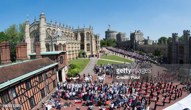 General view as Prince Harry, Duke of Sussex and Meghan, Duchess of Sussex ride by carriage following their wedding at St George's Chapel, Windsor...