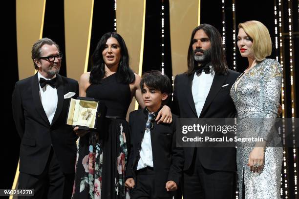 Director Nadine Labaki receives the Jury Prize award for 'Capharnaum' as Gary Oldman, actor Zain Alrafeea, producer Khaled Mouzanar and Jury member...