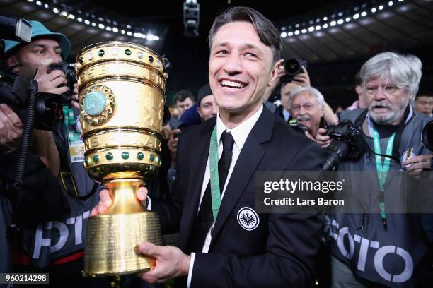 Head coach of Eintracht Frankfurt Niko Kovac caries the DFB Cup trophy after winning the DFB Cup final against Bayern Muenchen at Olympiastadion on...