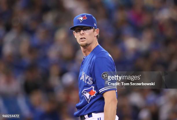 Tyler Clippard of the Toronto Blue Jays reacts after giving up a grand slam home run in the eighth inning during MLB game action against the Oakland...
