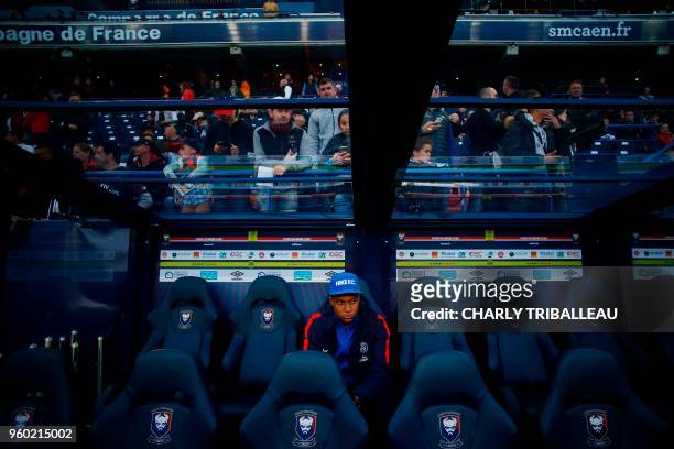 Paris Saint-Germain's French forward Kylian Mbappe sits before the French L1 football match between Caen and Paris on May 19 at the Michel d'Ornano...