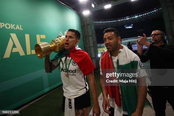 Carlos Salcedo of Frankfurt and Marco Fabian of Frankfurt walk out of the arena with the trophy after the DFB Cup final between Bayern Muenchen and...