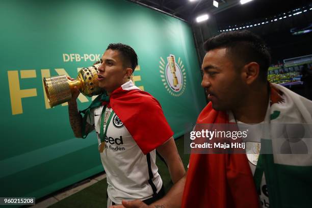 Carlos Salcedo of Frankfurt and Marco Fabian of Frankfurt walk out of the arena with the trophy after the DFB Cup final between Bayern Muenchen and...