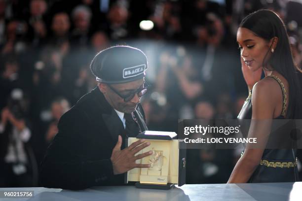 Director Spike Lee and US actress Laura Harrier pose with the trophy on May 19, 2018 during a photocall after Lee won the Grand Prix for the film...